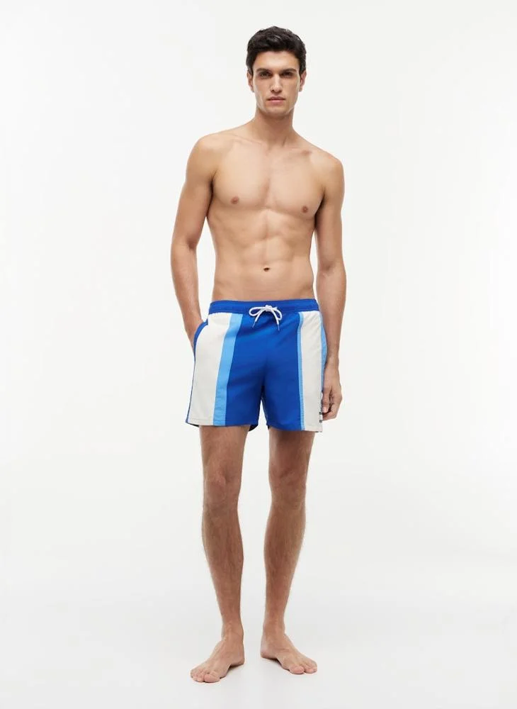 TOMMY HILFIGER  Heritage Colour-Blocked Mid Length Swim Shorts for Men | Best Price UAE